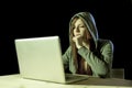 Young attractive teen woman wearing hood on hacking laptop computer cybercrime cyber crime concept Royalty Free Stock Photo