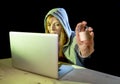 young attractive teen woman wearing hoodie hacking laptop cybercrime cyber crime concept