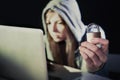 young attractive teen woman wearing hoodie hacking laptop cybercrime cyber crime concept