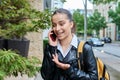 Young teenage girl talking on phone, outdoor on street of modern city Royalty Free Stock Photo