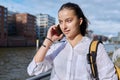 Young attractive teenage girl talking on mobile phone, outdoor Royalty Free Stock Photo
