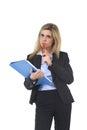 Young attractive and thoughtful business woman with blue folder and pen thinking about project Royalty Free Stock Photo