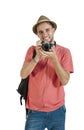 Young attractive tourist guy with camera and headphones isolated on white