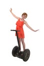 Young attractive tourist woman in chic summer dress smiling happy hands free riding electrical segway