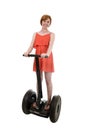 Young attractive tourist woman in chic summer dress smiling happy riding electrical segway Royalty Free Stock Photo