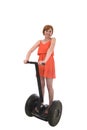 Young attractive tourist woman in chic summer dress smiling happy riding electrical segway Royalty Free Stock Photo