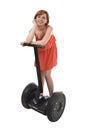 Young attractive tourist woman in chic summer dress smiling happy riding electrical segway Royalty Free Stock Photo