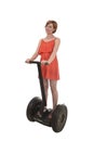 Young attractive tourist woman in chic summer dress smiling happy riding electrical segway Royalty Free Stock Photo