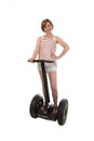 Young attractive tourist woman in summer shorts smiling happy riding electrical segway