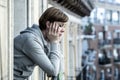 Young attractive unhappy depressed lonely woman looking sad on the balcony at home Royalty Free Stock Photo