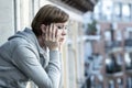 Young attractive unhappy depressed lonely woman looking sad on the balcony at home Royalty Free Stock Photo