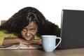 Young attractive unhappy and exhausted black African American woman working lazy on Monday at office computer desk feeling overwhe