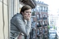 Young attractive unhappy lonely woman suffering from depression looking sad on the balcony at home Royalty Free Stock Photo