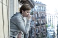 Young attractive unhappy lonely woman suffering from depression looking worried on the balcony at home Royalty Free Stock Photo