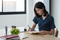 Young attractive university student take note, Asian woman writes notes, planning working process, sitting at classroom Royalty Free Stock Photo