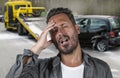 Young attractive upset and stressed man feeling overwhelmed after suffering car accident damaging the vehicle for insurance Royalty Free Stock Photo
