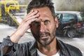 Young attractive upset and stressed man feeling overwhelmed after suffering car accident damaging the vehicle for insurance Royalty Free Stock Photo