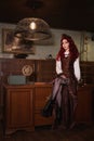 Young attractive vintage steampunk girl indoors