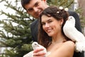 Young attractive wedding couple with pigeons pair Royalty Free Stock Photo