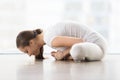 Young attractive woman in baddha konasana pose against floor win