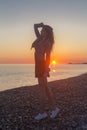 Young attractive woman on the beach at sunset time Royalty Free Stock Photo