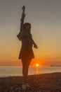 Young attractive woman on the beach at sunset time Royalty Free Stock Photo