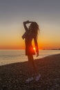 Young attractive woman on the beach at sunset time Royalty Free Stock Photo
