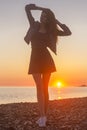 Young attractive woman on the beach at sunset time Royalty Free Stock Photo