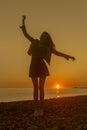 Young attractive woman on the beach at sunset time Royalty Free Stock Photo