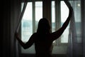 Young attractive woman in beautiful underwear near the window. Portrait of a woman at home. Royalty Free Stock Photo