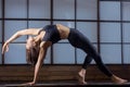 Young attractive woman in Bending Side Plank pose, evening pract Royalty Free Stock Photo