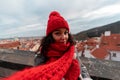 Young Attractive Woman With Big Cozy Red Scarf And Red Hat On Beautiful Prague Cityscape