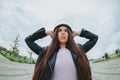 Young attractive woman biker wearing bike safety helmet while standing at empty stadium