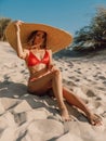 Young attractive woman in bikini with big hat posing at sandy beach Royalty Free Stock Photo