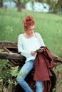 Young attractive woman is busy with her mobile phone doing selfies, writing, reading Royalty Free Stock Photo