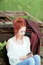 Young attractive woman is busy with her mobile phone doing selfies, writing, reading Royalty Free Stock Photo