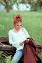 Young attractive woman is busy with her mobile phone doing selfies, writing, reading Royalty Free Stock Photo