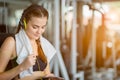 Young attractive woman caucasian sitting and listening to music by earphones connect to smart phone.