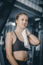 Young attractive woman caucasian sitting and using towel to wipe the sweat.