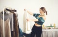 Young attractive woman choosing clothes for party or festive dinner at home, deciding what to wear Royalty Free Stock Photo