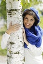 Young attractive woman close to a birch tree