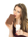 Young Attractive Woman Comparing a Chocolate Bar to a Glass of Sugar Royalty Free Stock Photo