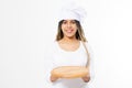 Young attractive woman in cooking hat holding empty pizza tray isolated on white background. Copy space and mock up. Blank Royalty Free Stock Photo