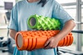 Woman doing fitness exercises in a gym an holding massage foam rollers. Royalty Free Stock Photo