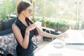 Young attractive woman drinks coffee and works with laptop in an Royalty Free Stock Photo