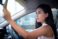 Young attractive woman driver sitting on seat inside car using h Royalty Free Stock Photo