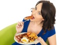 Young Attractive Woman Eating a Full English Breakfast Royalty Free Stock Photo