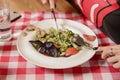 Young attractive woman eating meal set of spaghetti, green spinach pasta. Still life, eating out in restaurant Royalty Free Stock Photo