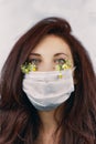 Young attractive woman in floral face mask