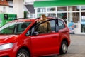 Young attractive woman gets out of her car by gas station to refill car with petrol or gas. People refuel gasoline Royalty Free Stock Photo